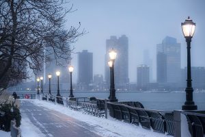 Photograph of street lamps along the Hudson River in New York City during the winter.